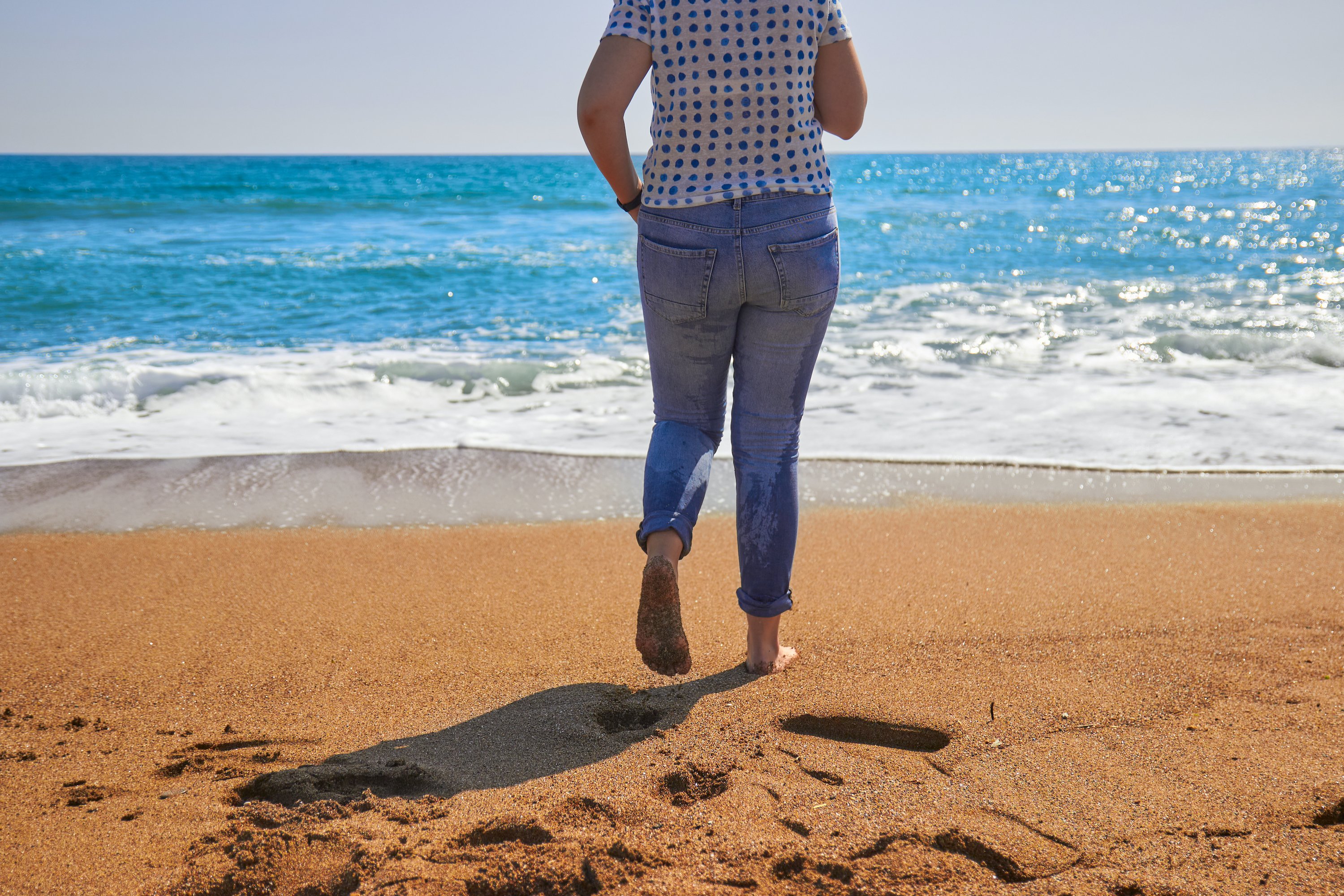 Girl in blue jeans running at the beach photo (582122) Travel and