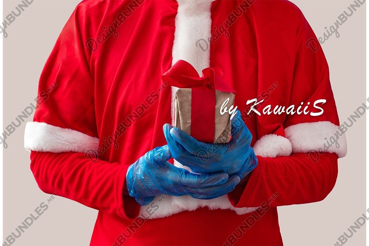 Santa Claus in gloves holds Christmas gift with (1049270)