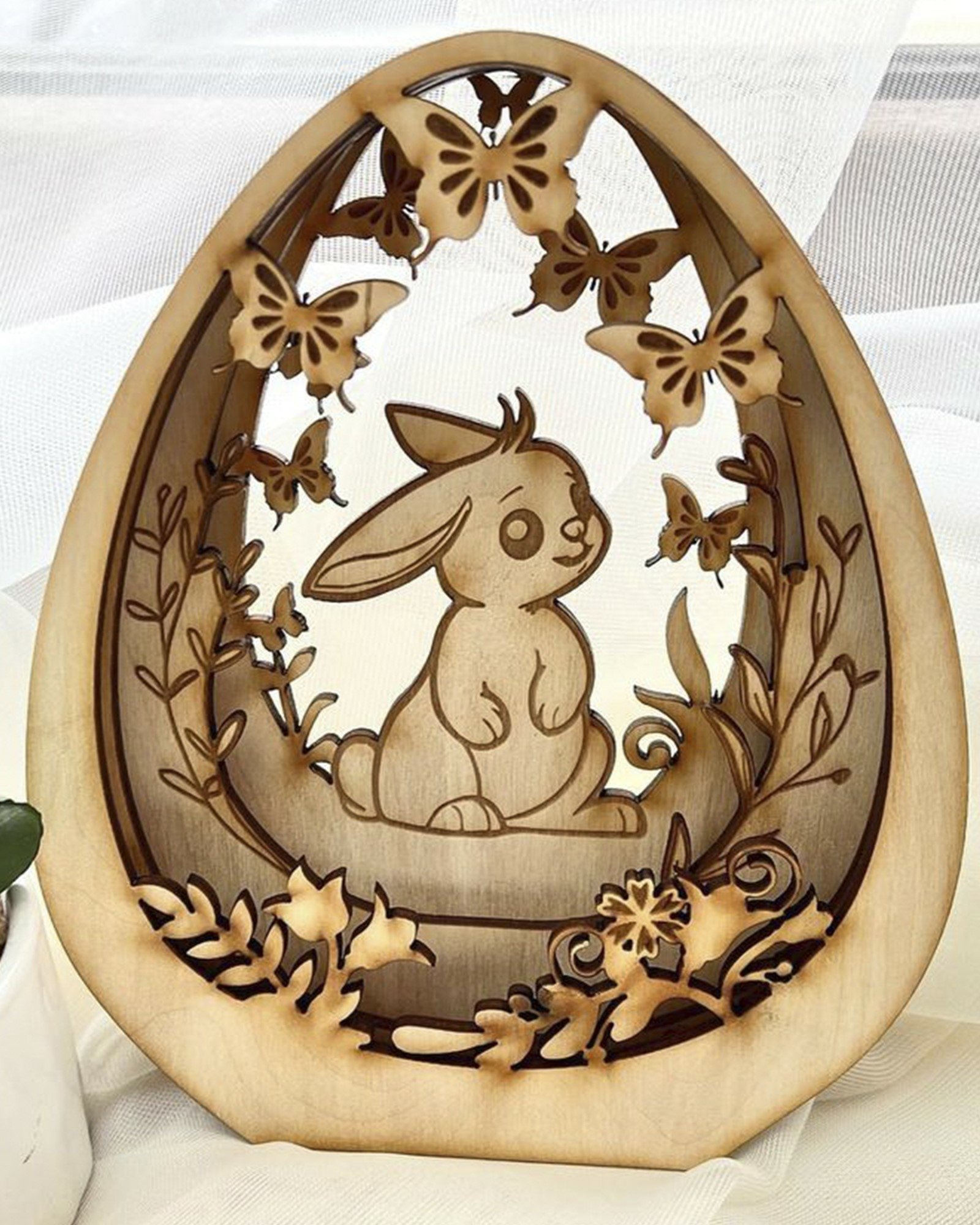 WHITE RESIN EASTER BUNNY ON WOVEN EGG main image 0