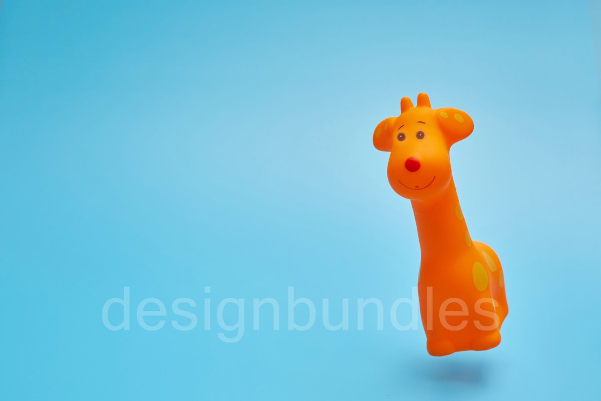 Toy giraffe flying in the air on a blue background. example image 1