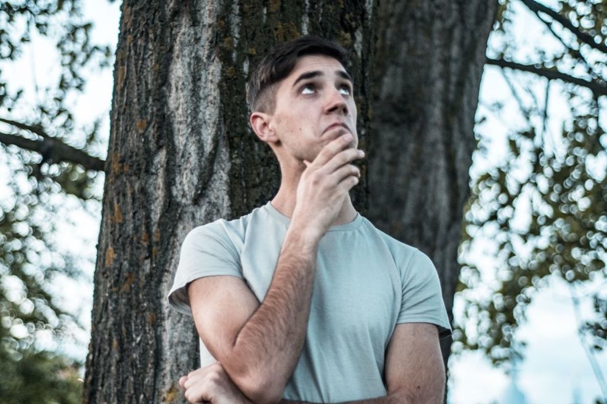 Young caucasian man walks in a park example image 1