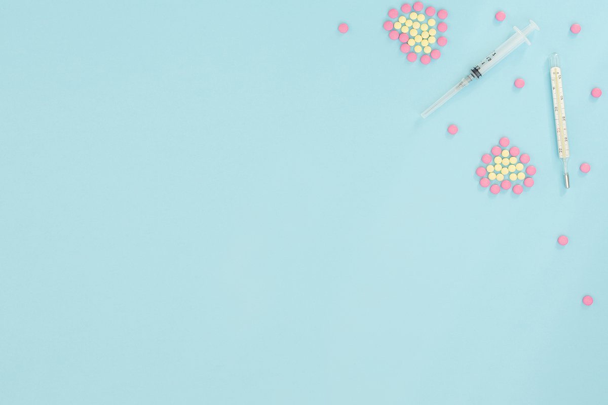 Hearts made of pink and yellow pills, thermometer, syringe example image 1