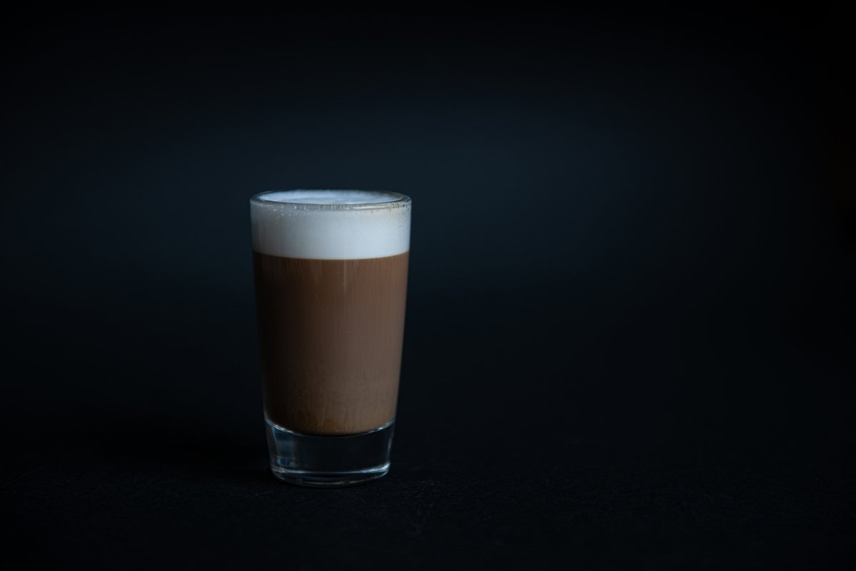 mini cup of cappuccino in a glass cup on black background example image 1