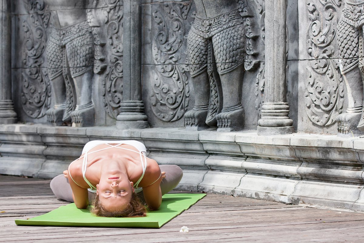 Woman doing yoga in abandoned temple on wooden platform example image 1