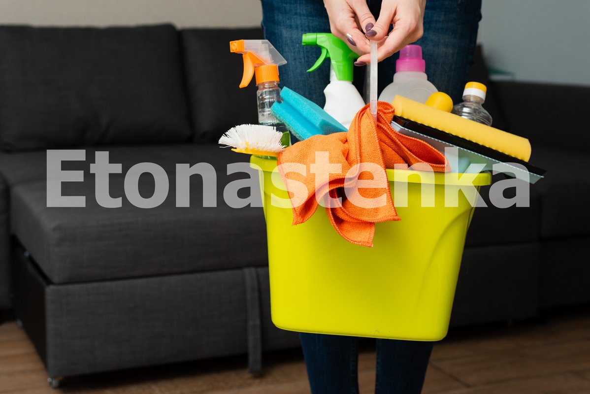 A girl is holding detergents in a bucket on the background. example image 1