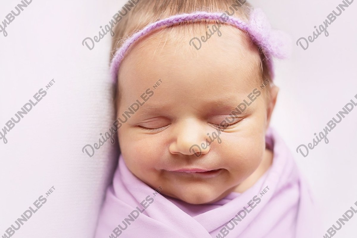 Smiley newborn baby girl is sleeping on the light pink example image 1