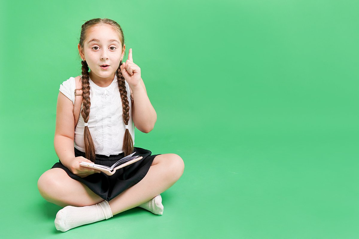 The little school girl on the floor with book example image 1