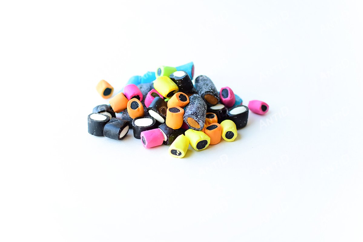 Multicolored licorice candy on a white background. example image 1