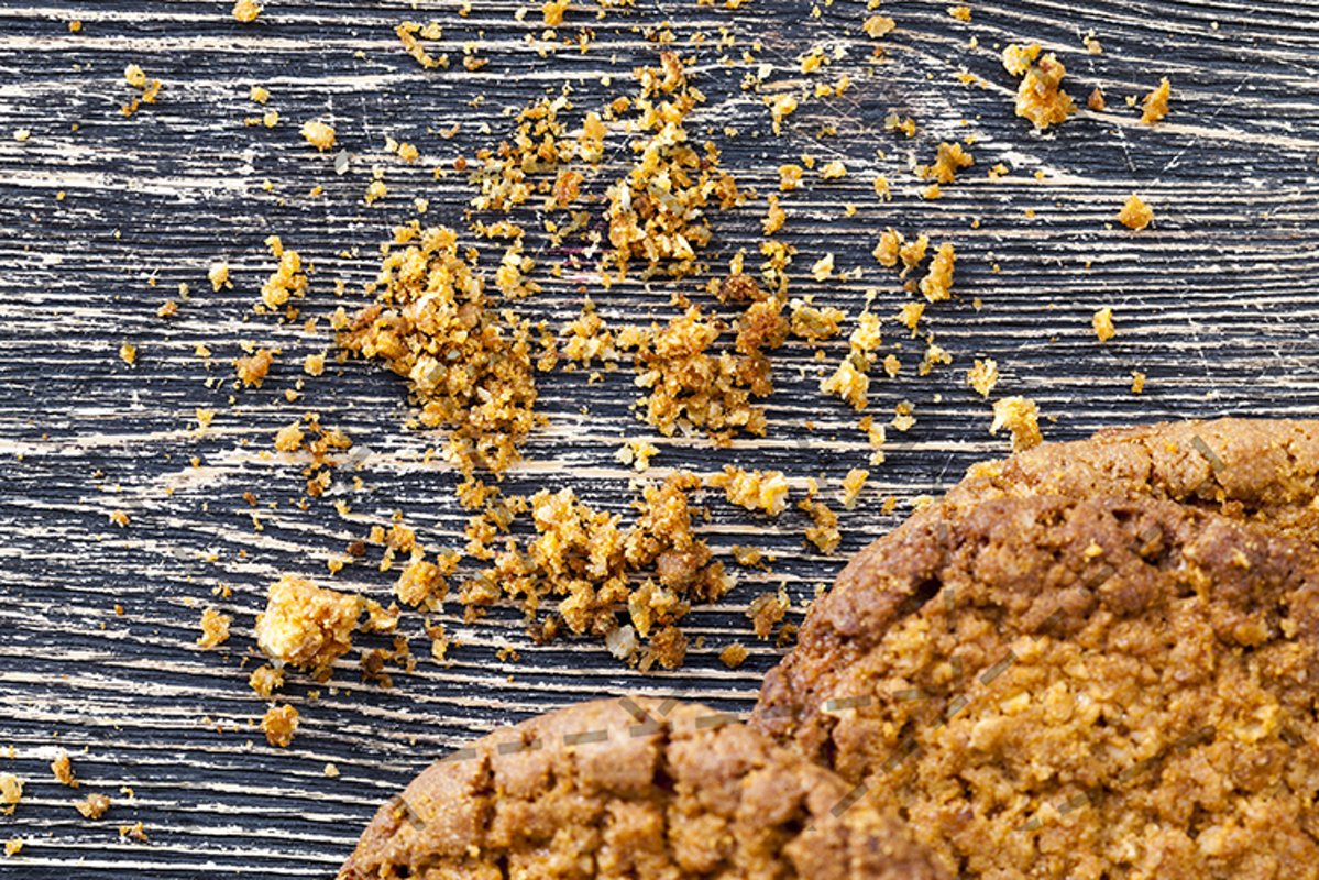 broken cookies with crumbs on the table. example image 1