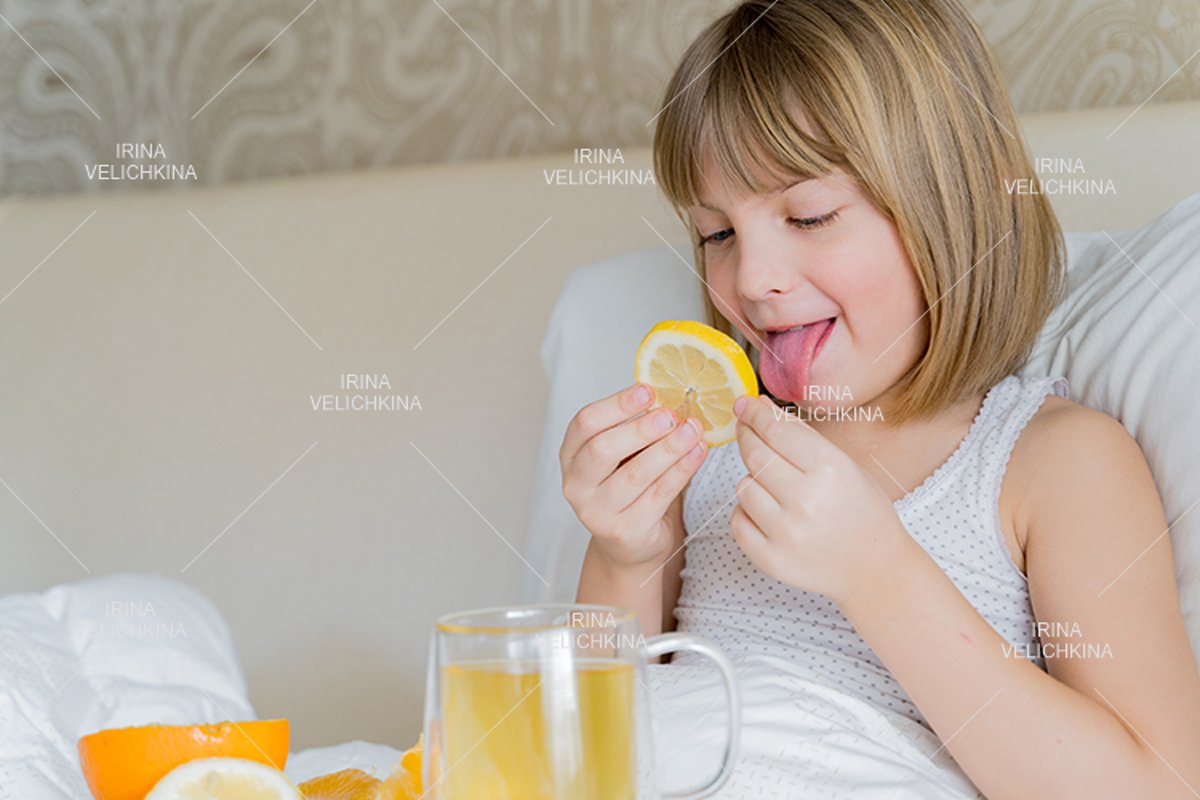 Sick girl in bed. Cup of flu drugs. Tea, orange,lemon,ginger example image 1