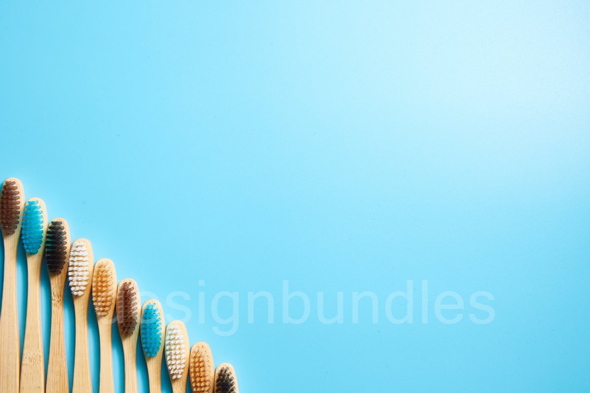Multi-colored wooden toothbrushes. Place for text example image 1