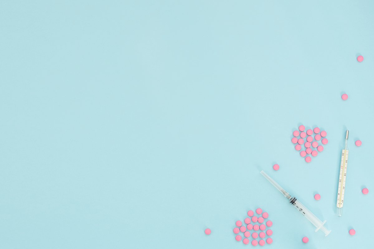 Two hearts made of pink pills, thermometer, syringe example image 1