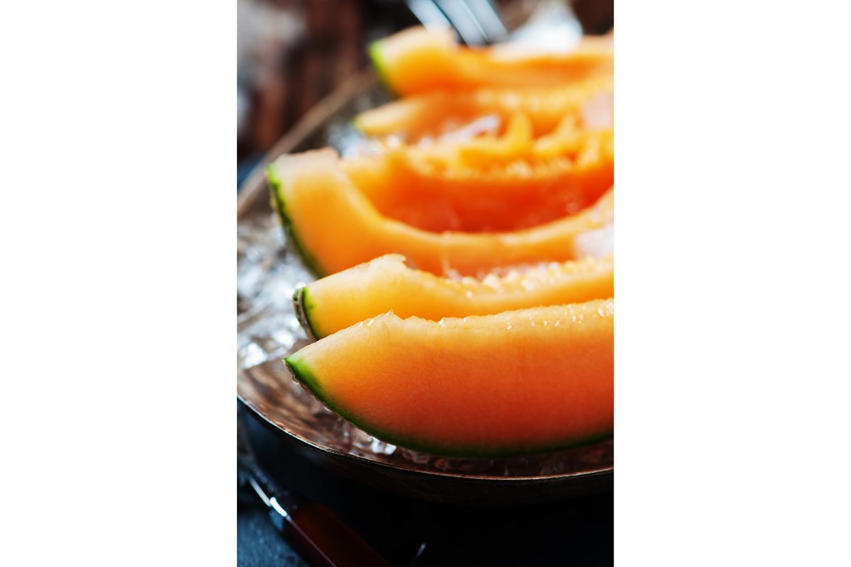 Fresh melon with ice on the wooden table, selective focus example image 1