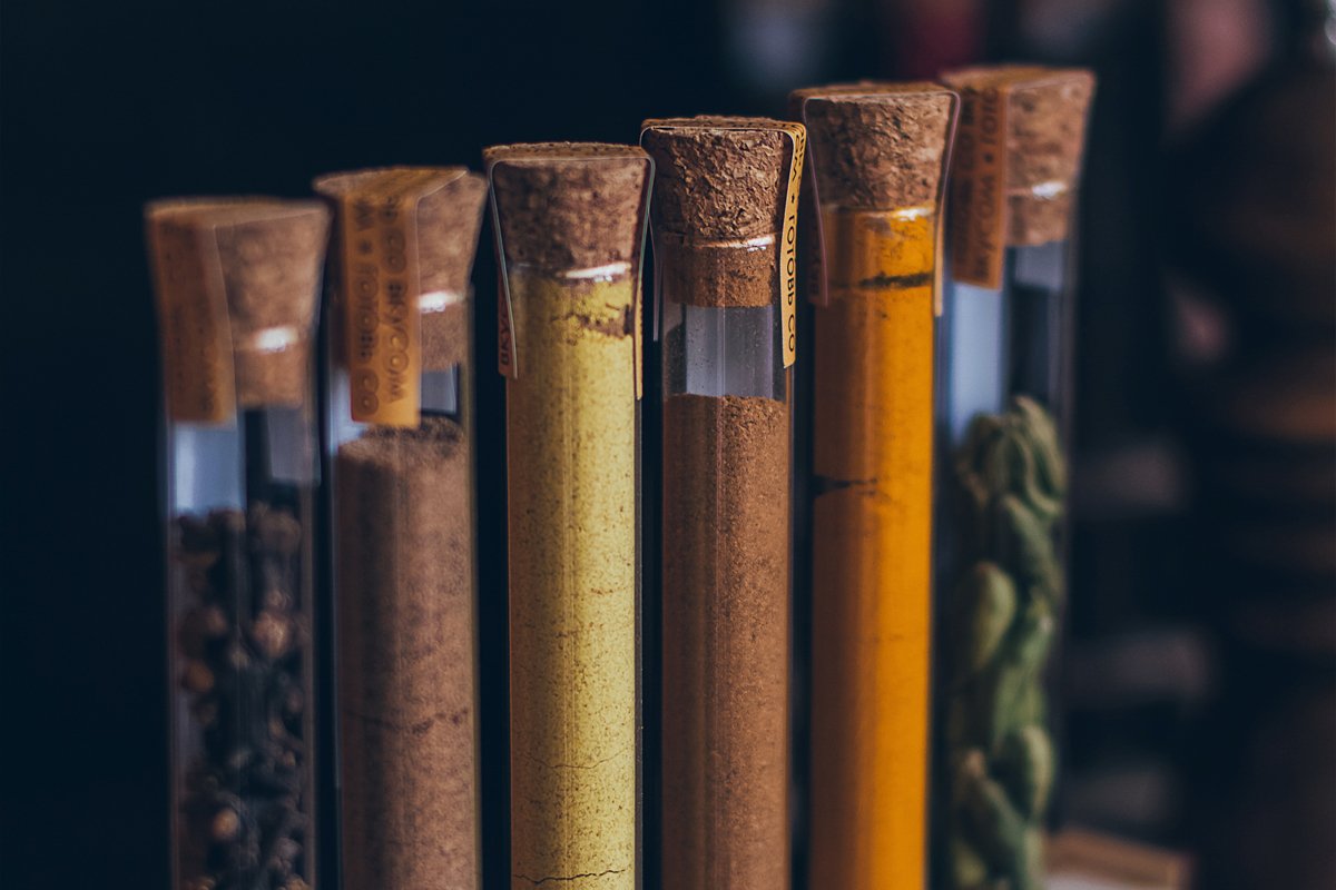 Colorful various spices in wooden spoons on old dark example image 1