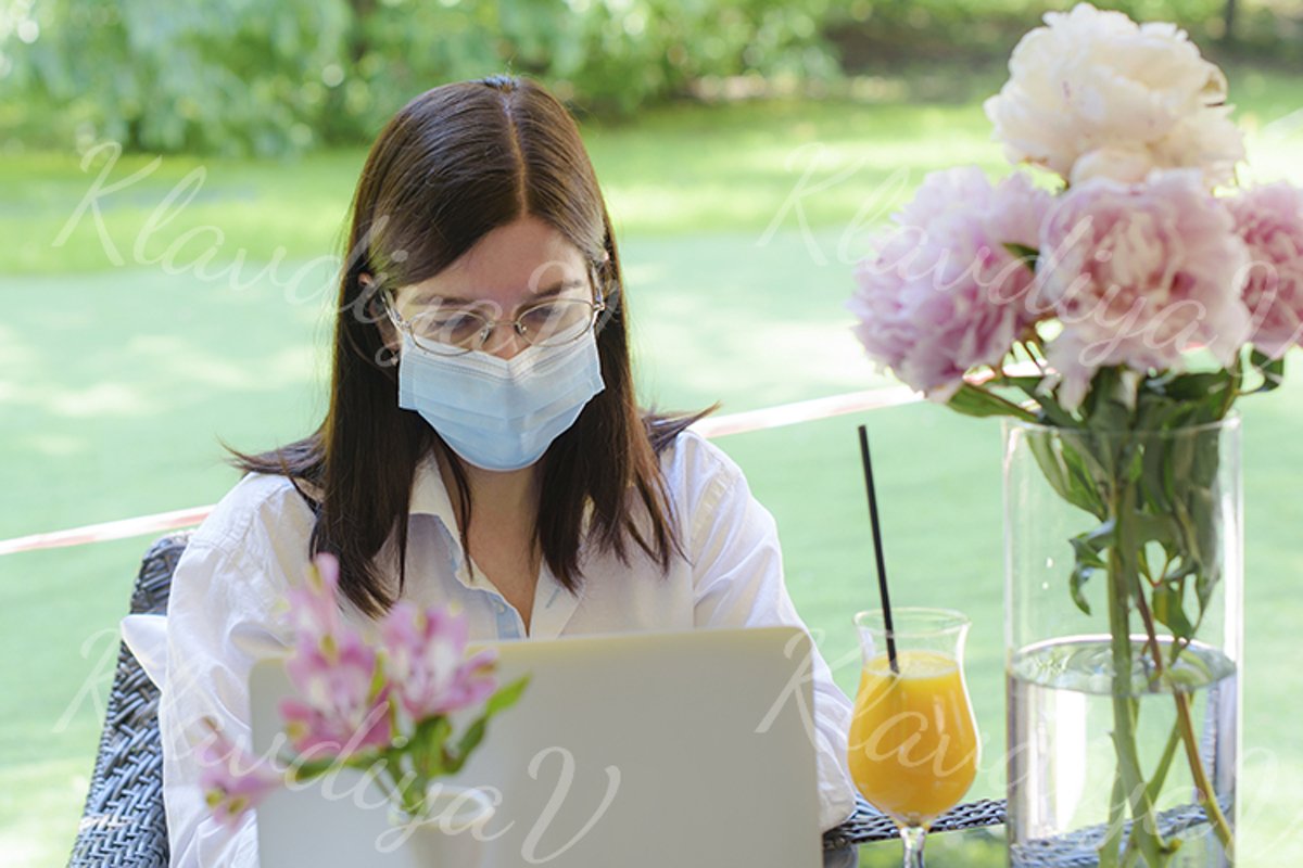 works at a laptop on the summer veranda example image 1