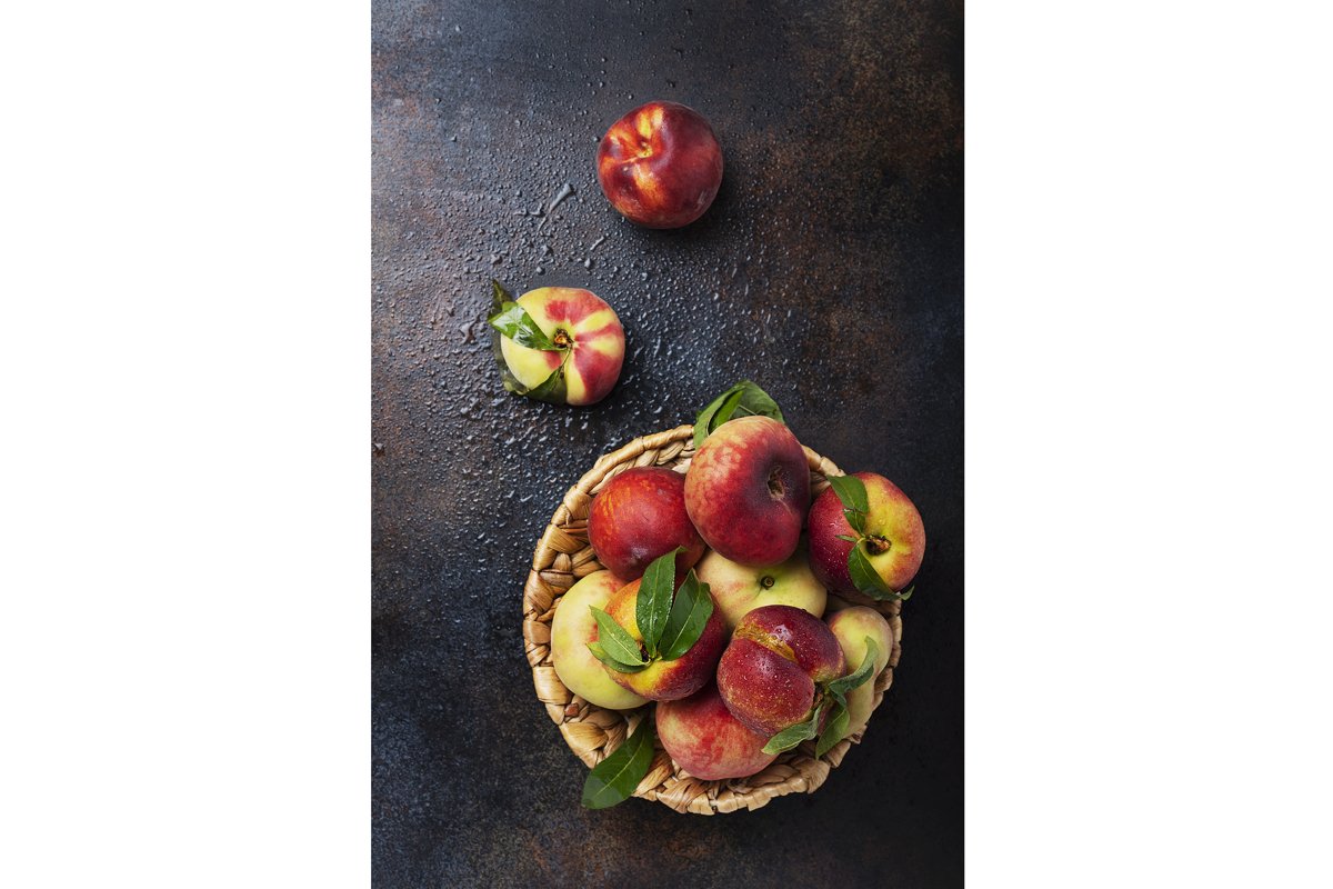 Top down view of sweet peaches with green leaves example image 1