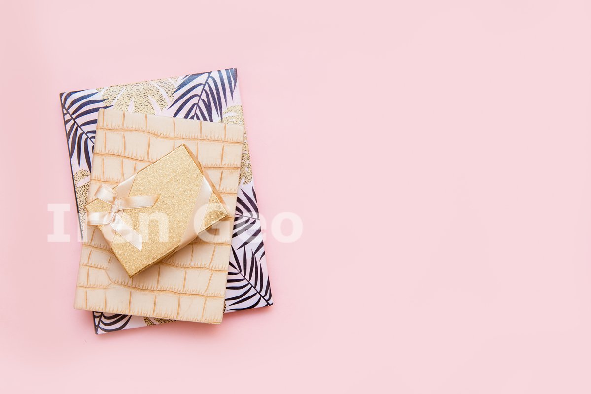 A stack of notebooks on a pink background example image 1