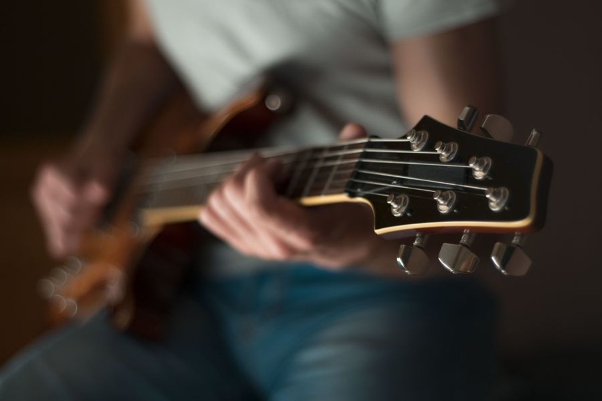 Man plays on electric guitar in studio example image 1