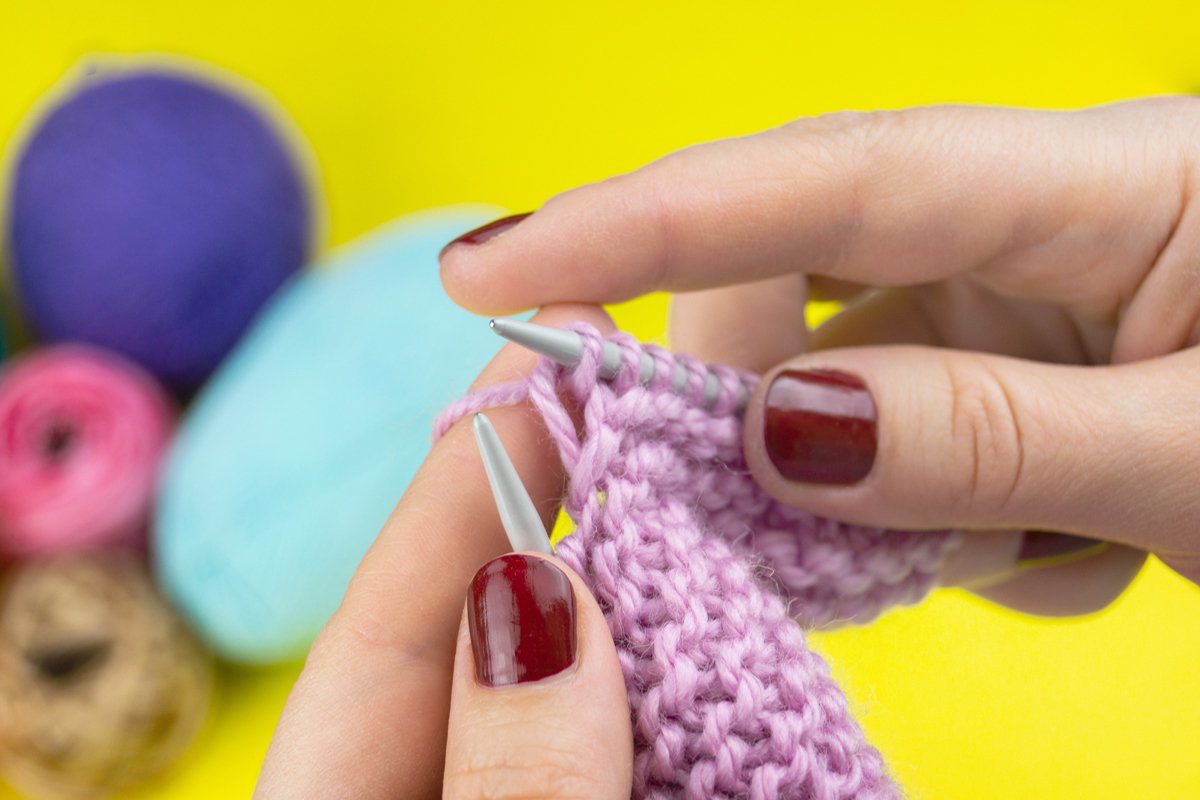 the girl knits a children's scarf on a yellow background example image 1