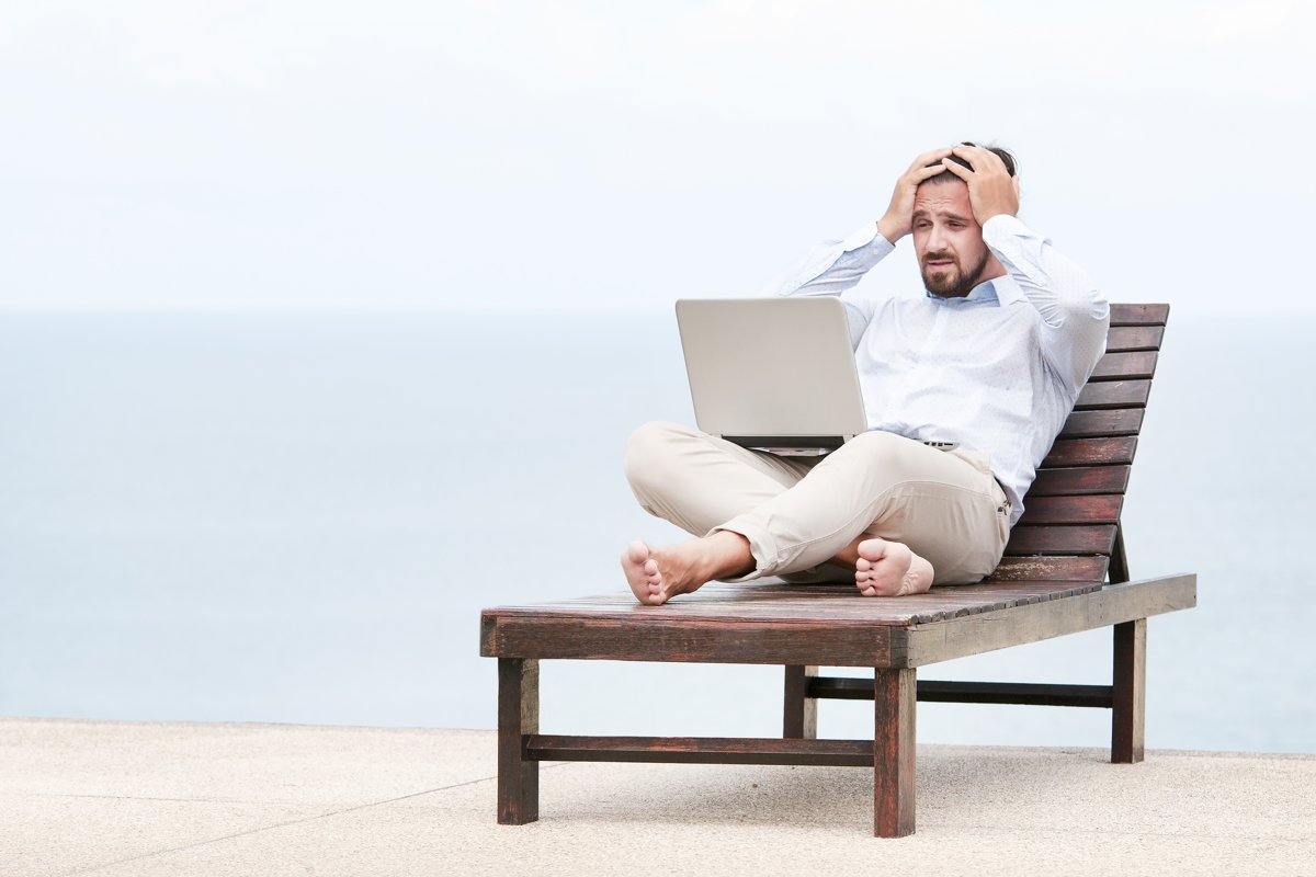 Businessman freelance on beach with laptop example image 1