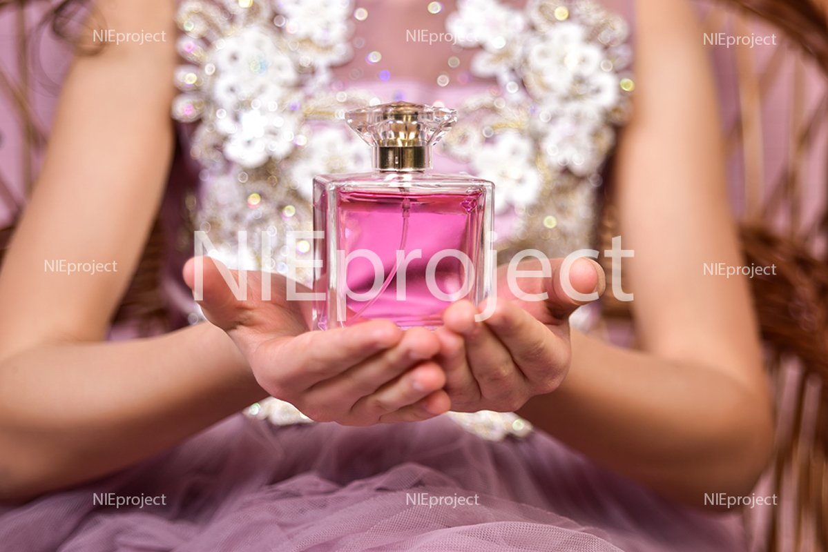kid girl with pink parfume bottle in her hands example image 1