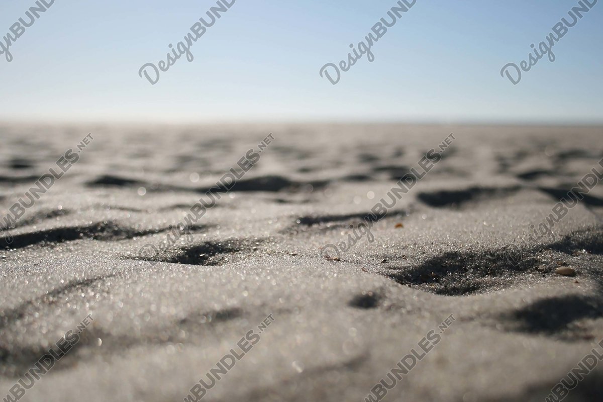 Stock Photo - Close-Up Of Sand On Beach Against Clear Sky example image 1