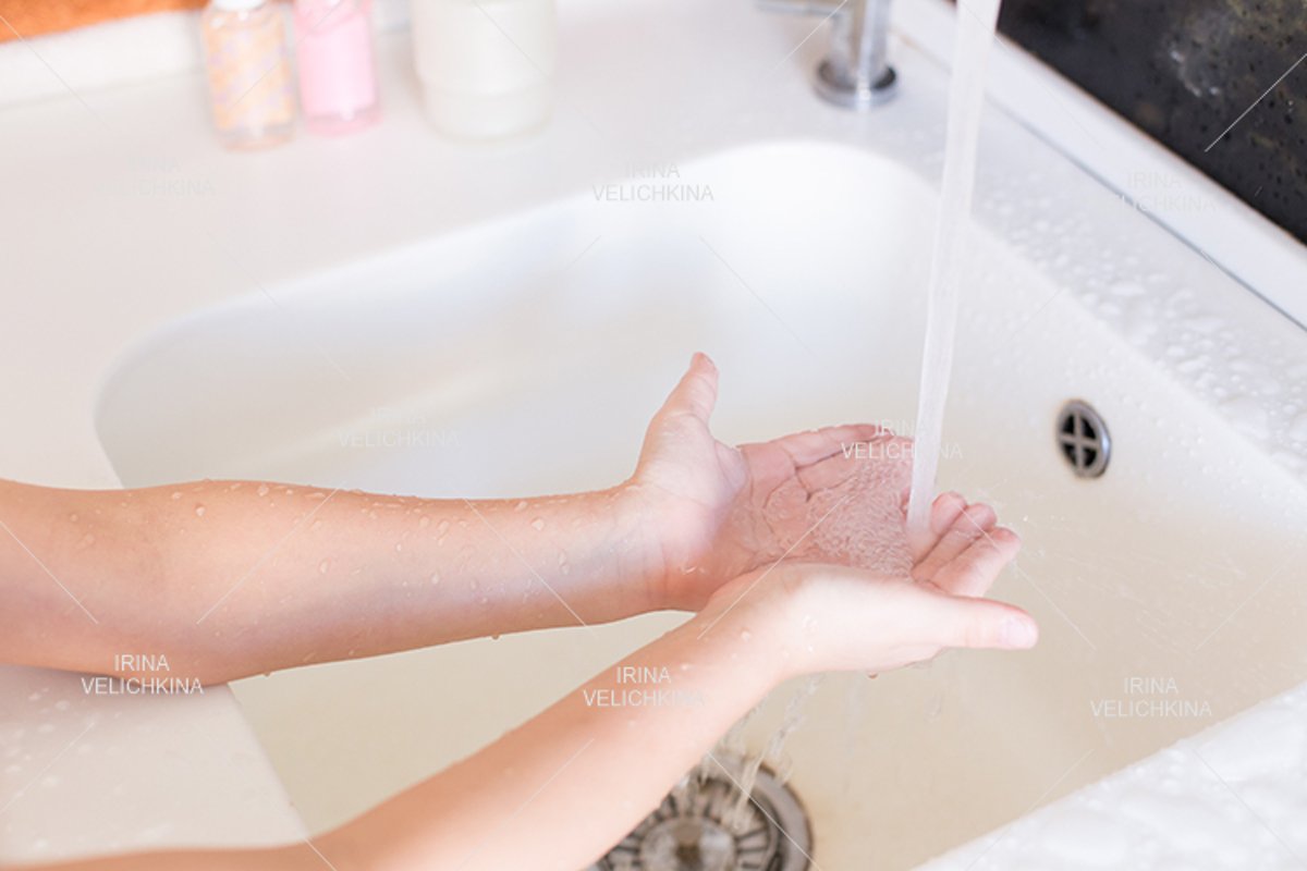 Girls wash their hands in the sink with soap in the foam example image 1