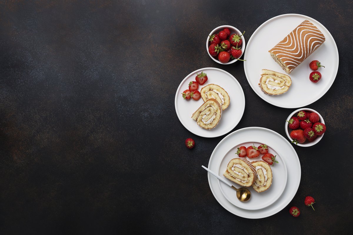 Sweet roll cake with white biscuit, cream and strawberry example image 1