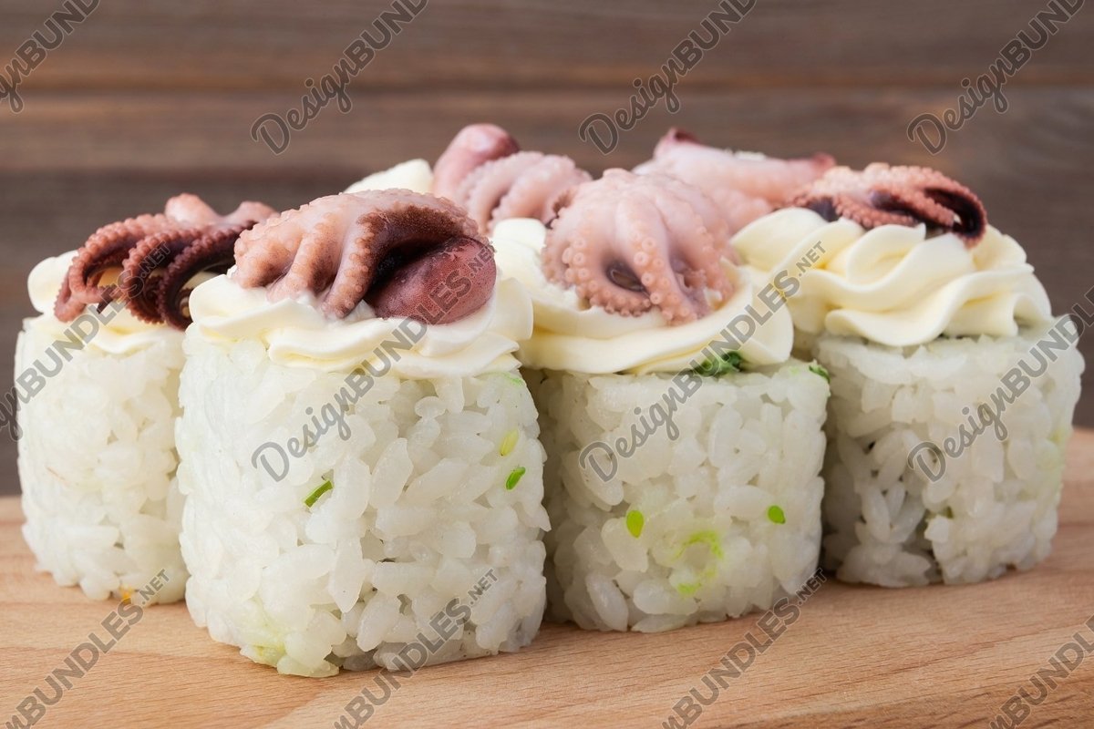 Sushi, rolls set with octopus close-up on a wooden table example image 1