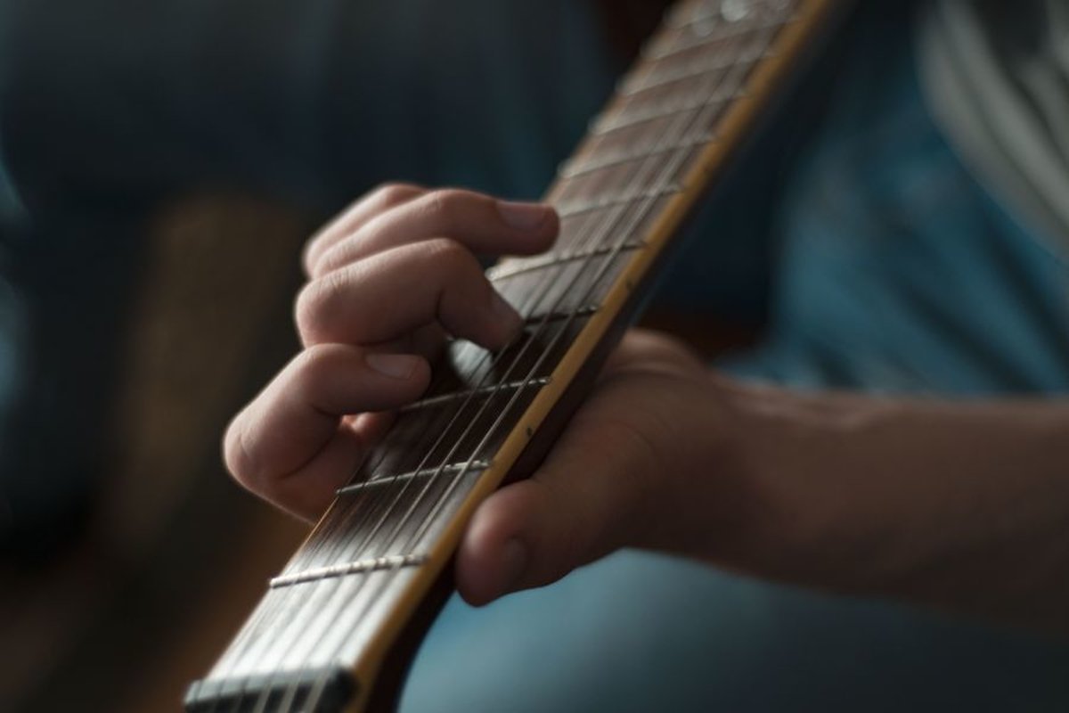 Man plays on electric guitar in studio example image 1