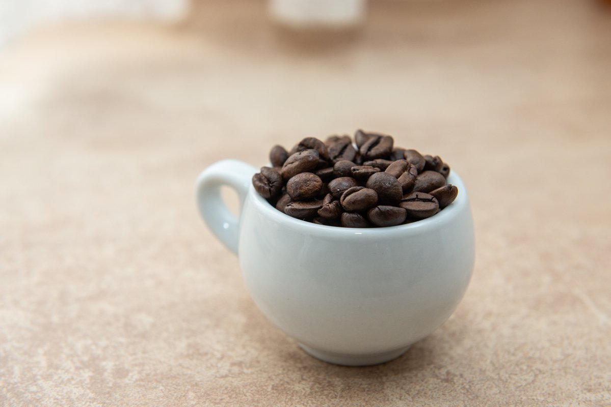 Cup of coffee full of coffee beans example image 1