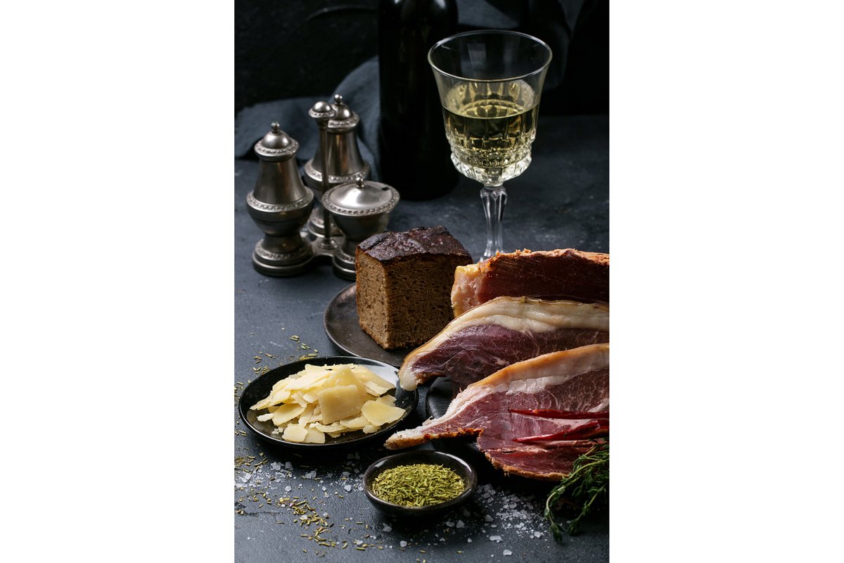 Prosciutto Ham served on a rustic wooden board example image 1