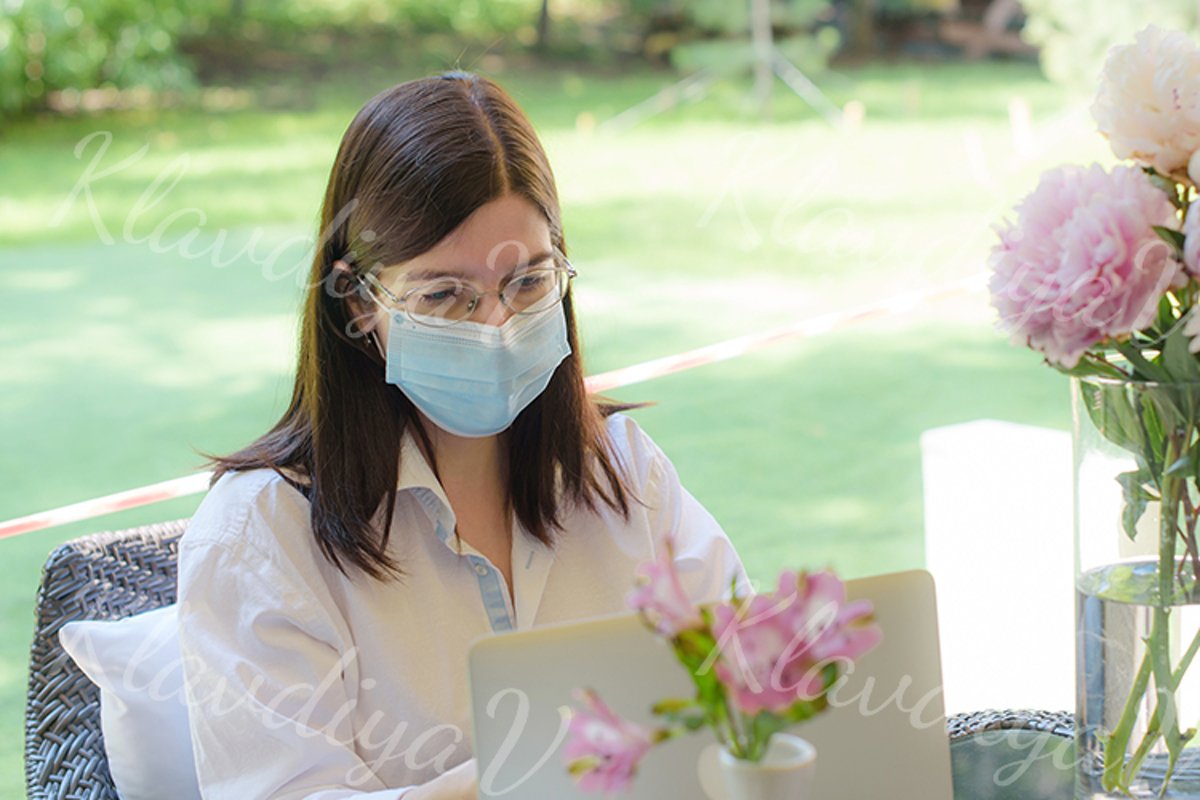 works at a laptop on the summer veranda example image 1