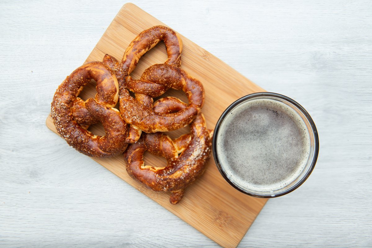 Freshly baked homemade soft pretzel with salt and glass beer example image 1