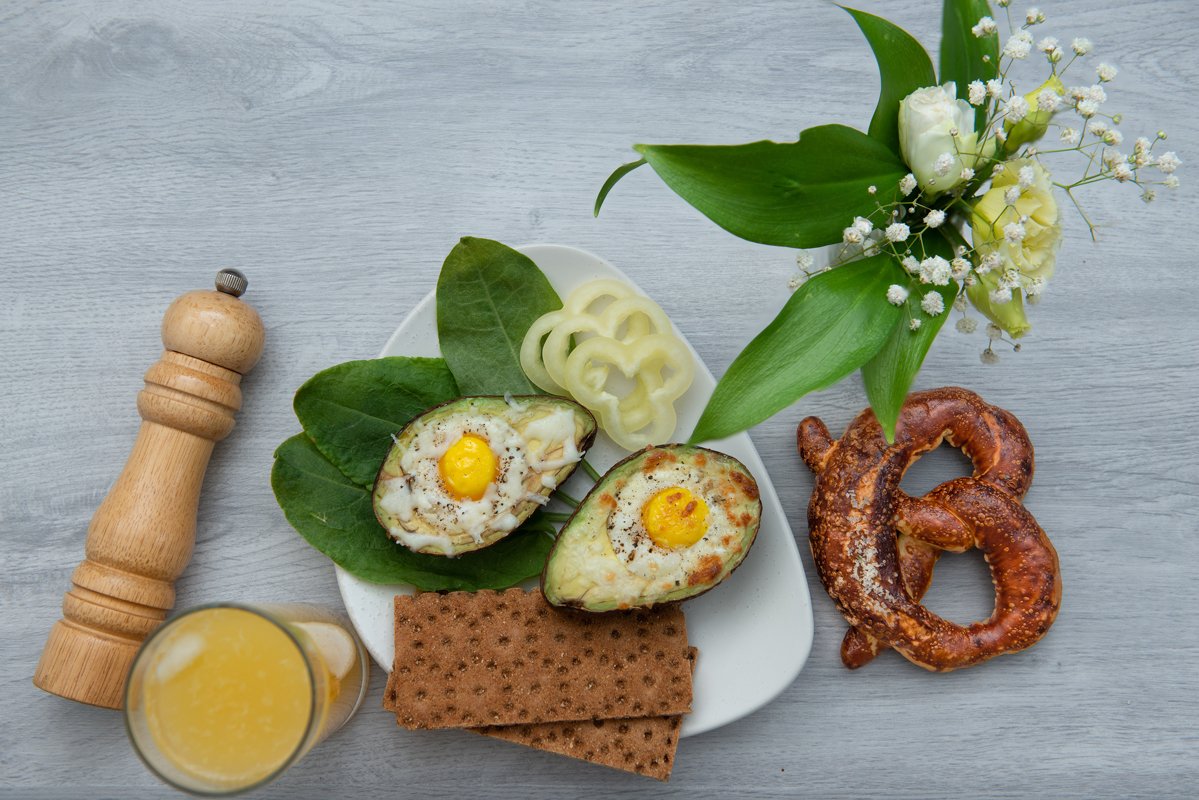 flat lay eggs baked in avocado on plate example image 1