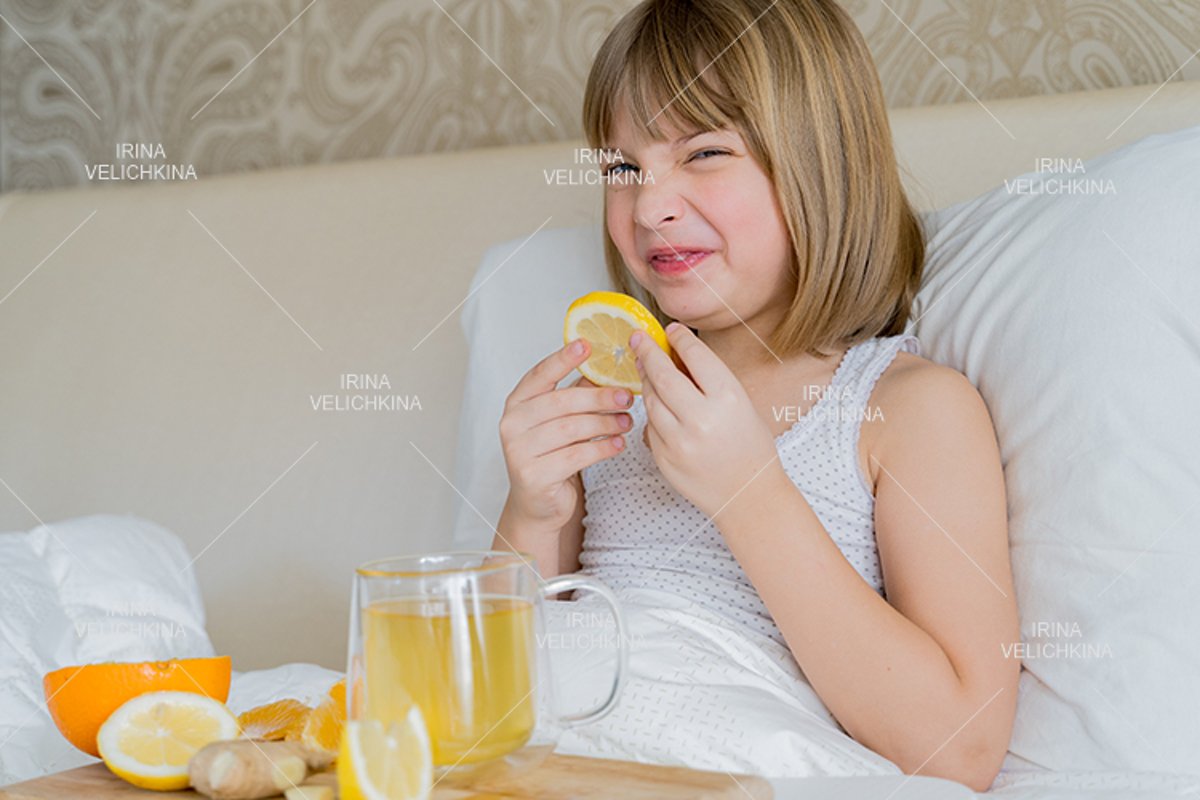 Sick girl in bed. Cup of flu drugs. Tea, orange,lemon,ginger example image 1