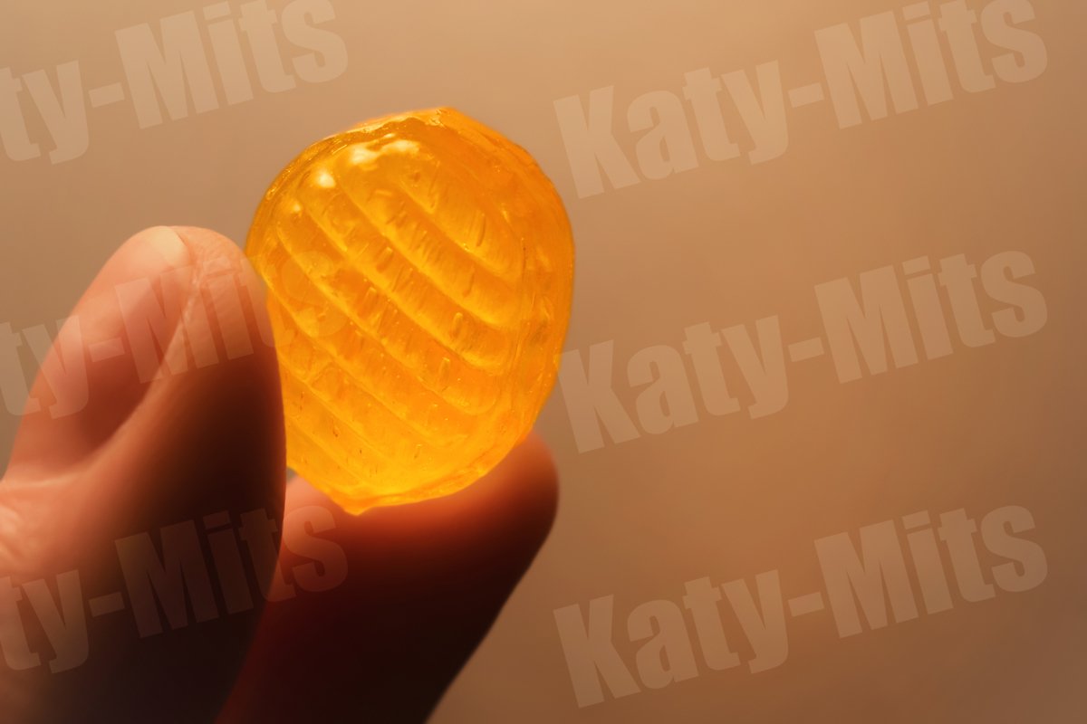 Hard sugar candy or cough drop in hand example image 1
