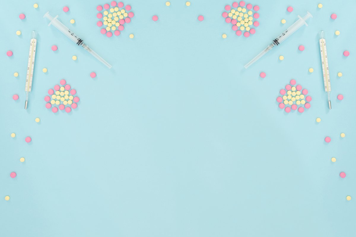 Hearts made of pink and yellow pills, thermometer, syringe example image 1