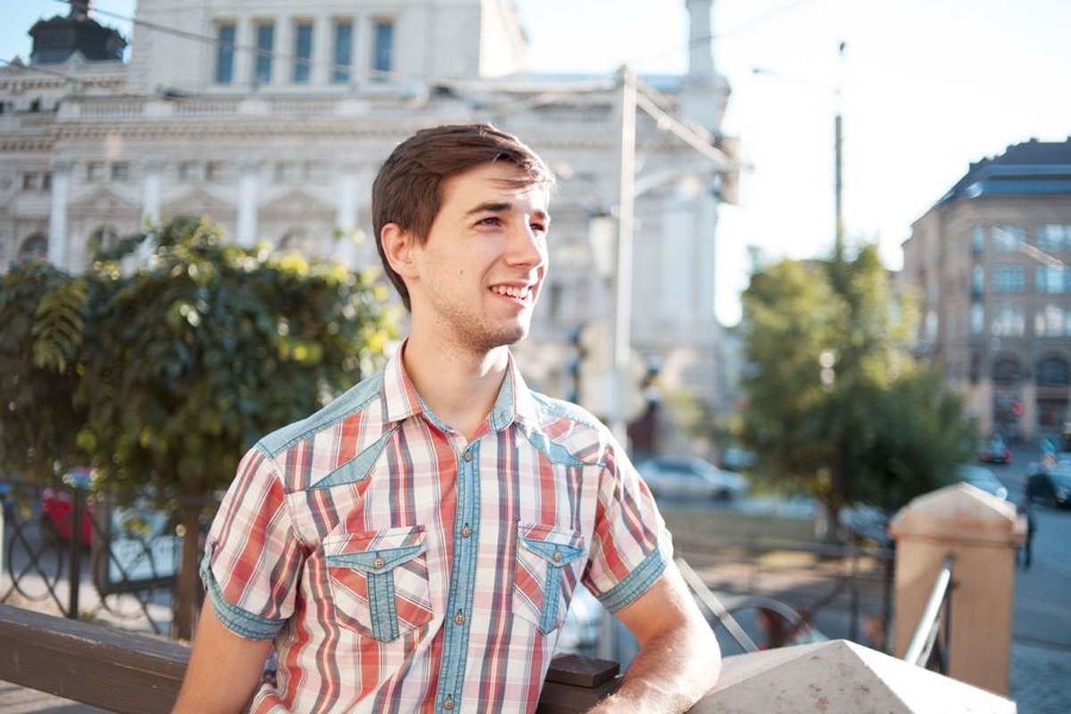 Young man walks in the city example image 1