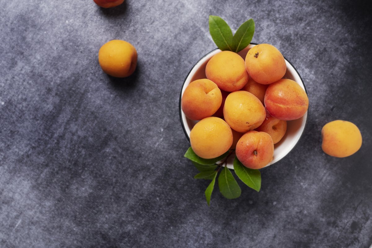 Sweet fresh apricots in the white bowl example image 1