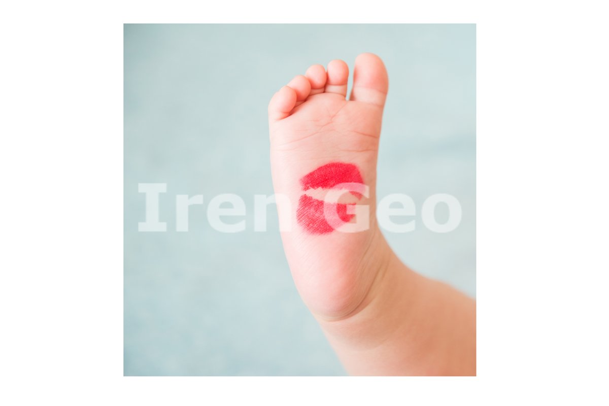 Baby's small foot with red lipstick from a kiss example image 1