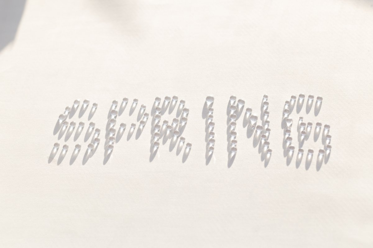 Word spring is created from drops of water. White background example image 1