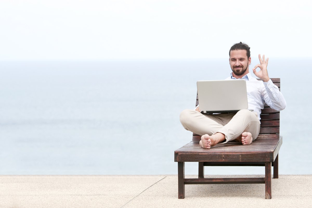 Businessman freelance on beach with laptop example image 1