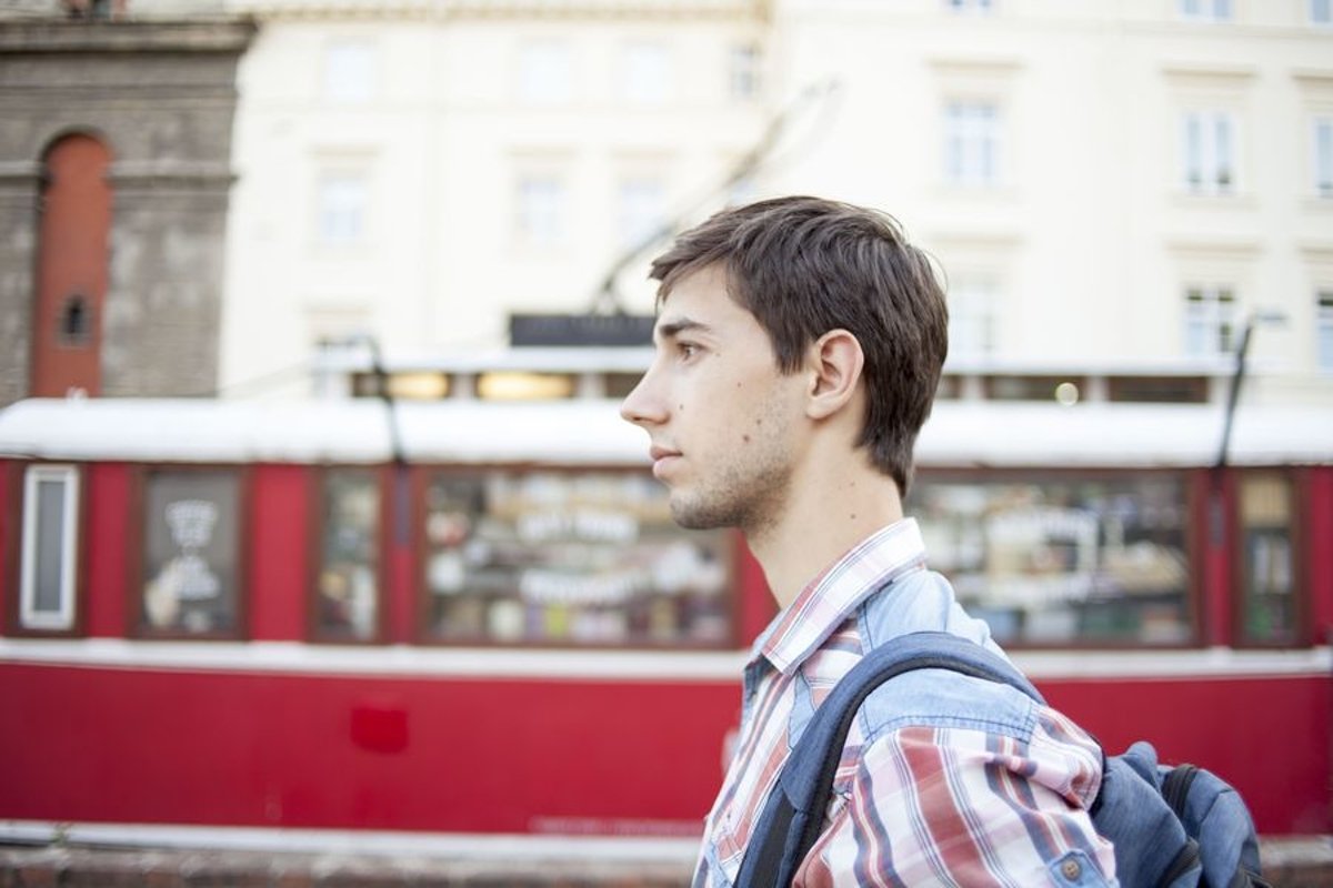 Young man walks in the city example image 1