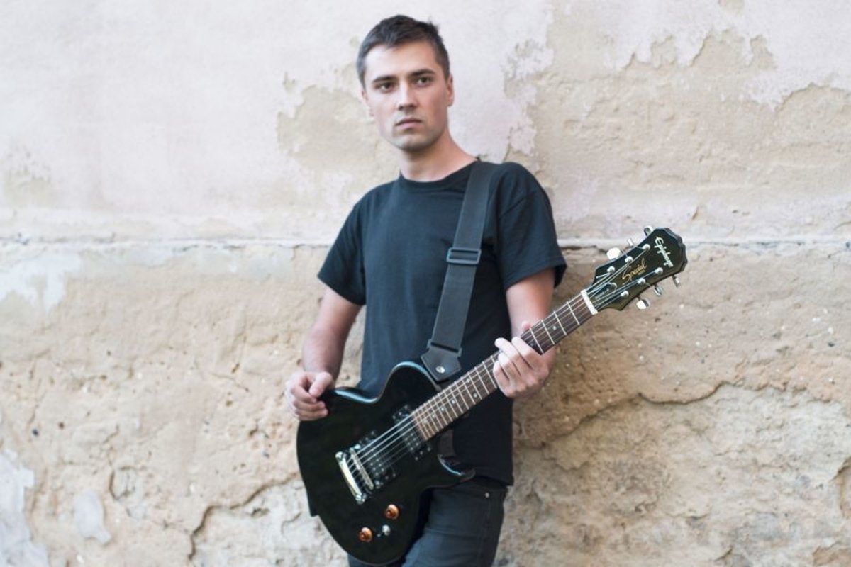 Young caucasian man with electric guitar example image 1
