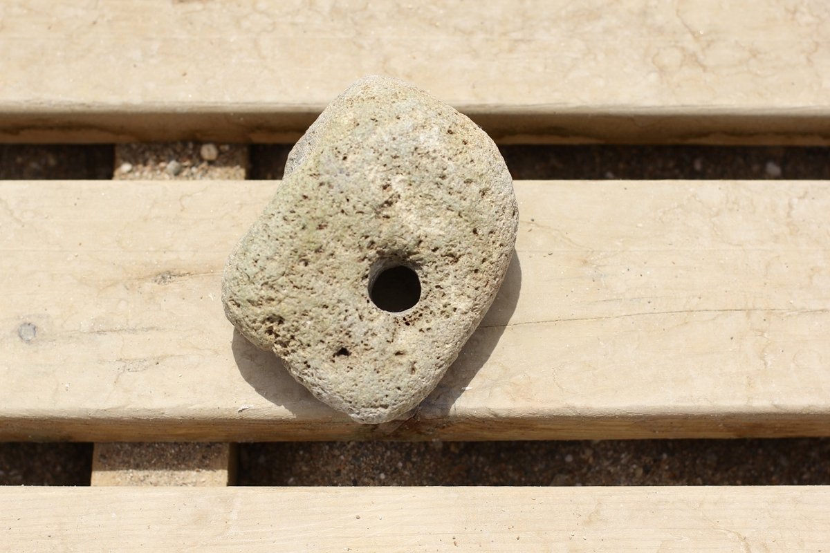 A large stone with a through hole example image 1