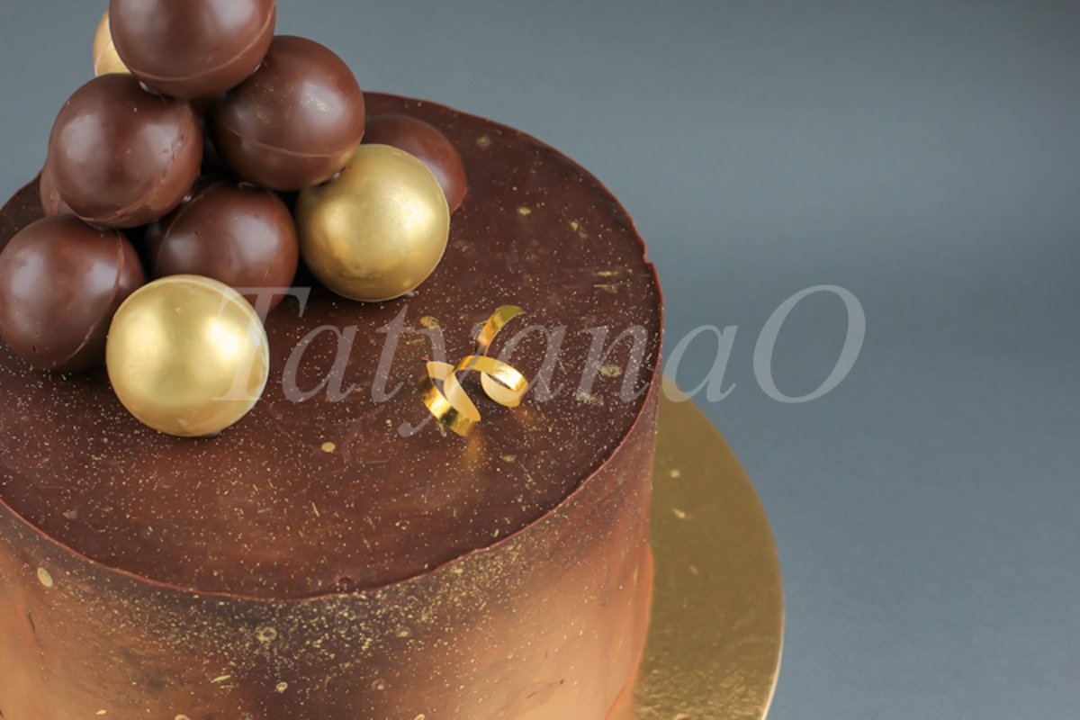Chocolate birthday cake with gold decorations. example image 1