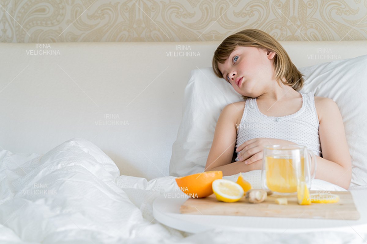 Sick girl in bed. Cup of flu drugs. Tea, orange,lemon,ginger example image 1