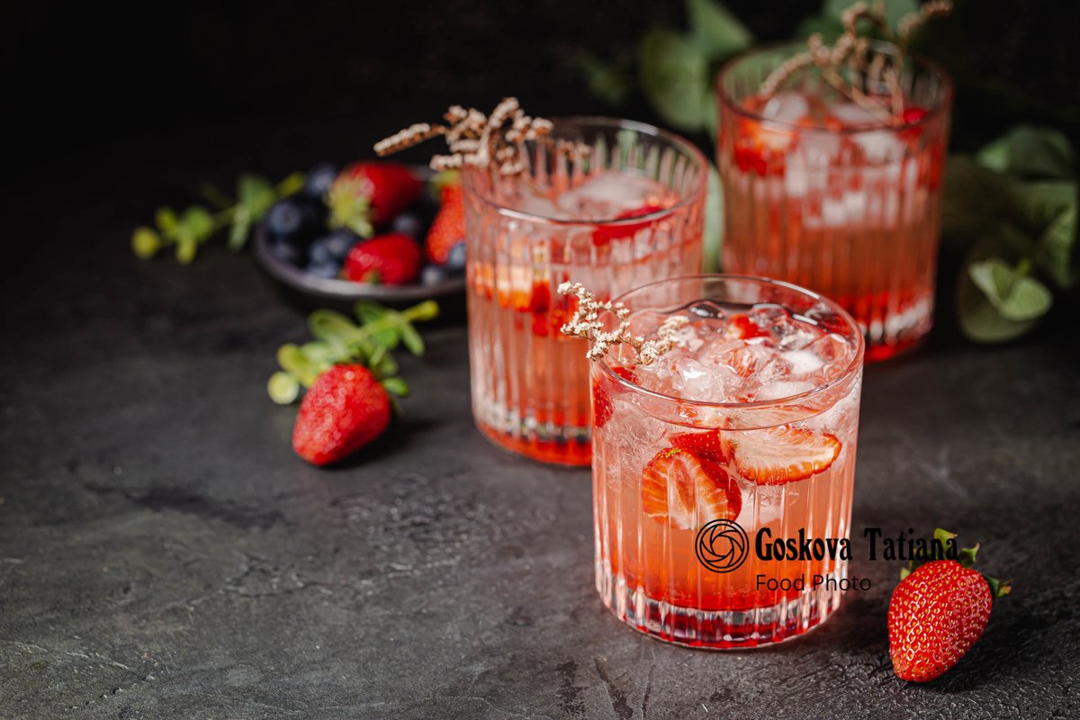 Photo of Cold fresh pink lemonade drink with ice in a glass example image 1
