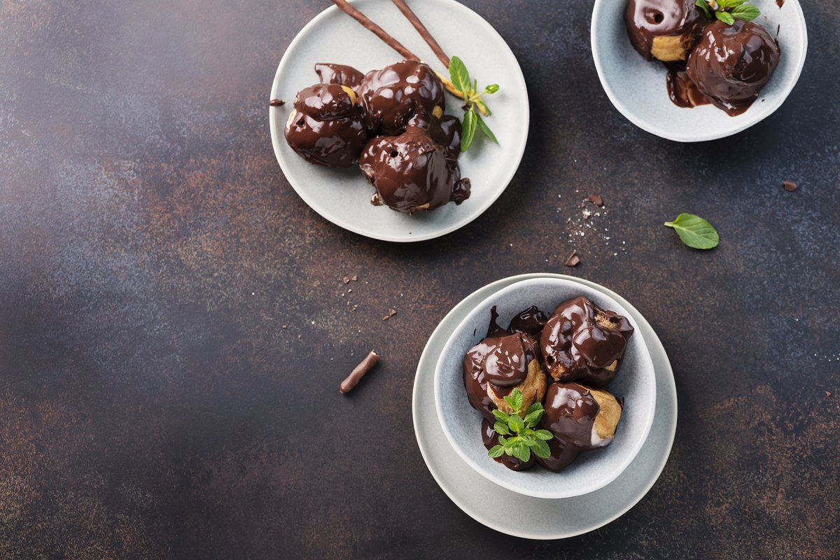 Traditional italian dessert profiteroles with chocolate example image 1